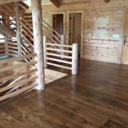 Log cabin home with dark hardwood flooring