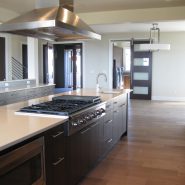 Modern kitchen shown with hardwood floors