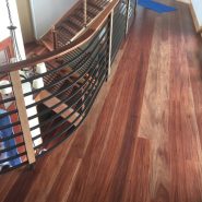 Custom hardwood flooring on wrap around interior balcony